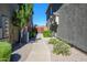 Private walkway to back entrance with mature landscaping and AC unit at 17365 N Cave Creek Rd # 246, Phoenix, AZ 85032
