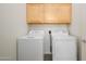 Laundry room with washer and dryer and upper cabinets at 17365 N Cave Creek Rd # 246, Phoenix, AZ 85032