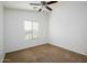 Well-lit bedroom featuring carpeted floors and a ceiling fan at 17365 N Cave Creek Rd # 246, Phoenix, AZ 85032