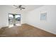 Bright bedroom with carpet, ceiling fan, and access to a private balcony at 17365 N Cave Creek Rd # 246, Phoenix, AZ 85032