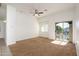 Bright living room with neutral carpet, balcony access, and ceiling fan at 17365 N Cave Creek Rd # 246, Phoenix, AZ 85032