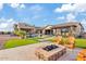 Luxury backyard oasis with a pool, fire pit, and expansive patio at 10803 W Dove Roost Rd, Queen Creek, AZ 85144