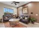 Spacious living area with leather furniture and large window at 10803 W Dove Roost Rd, Queen Creek, AZ 85144