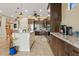 Spacious kitchen featuring granite countertops and dark wood cabinets at 10803 W Dove Roost Rd, Queen Creek, AZ 85144