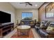 Comfortable living room, featuring leather sofas and a coffee table at 10803 W Dove Roost Rd, Queen Creek, AZ 85144