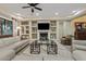 Elegant living room with built-in shelving and a fireplace at 10803 W Dove Roost Rd, Queen Creek, AZ 85144