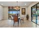 Elegant dining room with glass-top table and mountain views at 10803 W Dove Roost Rd, Queen Creek, AZ 85144
