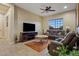 Relaxing living room with leather seating and a large flat-screen TV at 10803 W Dove Roost Rd, Queen Creek, AZ 85144