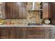Modern kitchen with granite countertops and ample cabinetry at 10803 W Dove Roost Rd, Queen Creek, AZ 85144