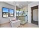 Spa-like bathroom with soaking tub, walk-in shower, and large windows at 3329 W Desert Dawn Dr, Phoenix, AZ 85083