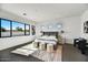 Spacious main bedroom with large windows, plush bedding, and sitting area at 3329 W Desert Dawn Dr, Phoenix, AZ 85083