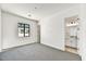 Spacious bedroom with grey carpet and an adjacent bathroom at 3329 W Desert Dawn Dr, Phoenix, AZ 85083