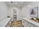 Bright laundry room with quartz countertops and built-in cabinets at 3329 W Desert Dawn Dr, Phoenix, AZ 85083