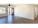 Spacious living area with wood-look tile floors, new door and large window at 1737 N Trevor Dr, Mesa, AZ 85201