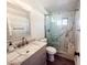 Bathroom with a single vanity, marble shower, and toilet at 1737 N Trevor Dr, Mesa, AZ 85201