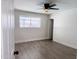 Well-lit bedroom featuring wood-look floors and ceiling fan at 1737 N Trevor Dr, Mesa, AZ 85201