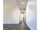 Bright hallway with wood-look floors and access to rooms at 1737 N Trevor Dr, Mesa, AZ 85201