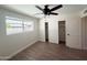 Spacious bedroom with wood-look floors, double closet and window at 1737 N Trevor Dr, Mesa, AZ 85201