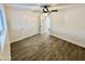 Bright bedroom with wood-look floors, double closet, and ceiling fan at 1737 N Trevor Dr, Mesa, AZ 85201