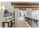 Elegant hallway with wood beams, art, and marble console table at 14511 E Windstone Trl, Scottsdale, AZ 85262