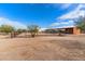 Covered horse stables with a dirt ground and desert landscape at 14511 E Windstone Trl, Scottsdale, AZ 85262
