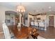 Elegant dining room with a rustic wooden table and a beautiful chandelier at 36107 N Desert Tea Dr, Queen Creek, AZ 85140