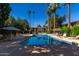 Community pool with lounge chairs and patio umbrellas at 4701 N 68Th St # 144, Scottsdale, AZ 85251