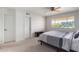 Bright bedroom with ceiling fan, window, and large closet at 4701 N 68Th St # 144, Scottsdale, AZ 85251