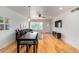 Bright living room with hardwood floors, dining area, and large TV at 4701 N 68Th St # 144, Scottsdale, AZ 85251