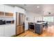 Open concept kitchen with island, stainless steel appliances and light wood floors at 4701 N 68Th St # 144, Scottsdale, AZ 85251