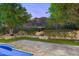 Landscaped backyard oasis with a pool, patio, and mountain views at 20242 N 103Rd Way # 1246, Scottsdale, AZ 85255
