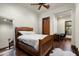 Bright bedroom with wooden bed frame, built-in desk and hardwood floors at 20242 N 103Rd Way # 1246, Scottsdale, AZ 85255
