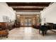 Spacious living room with hardwood floors, large windows, and a piano at 20242 N 103Rd Way # 1246, Scottsdale, AZ 85255