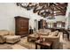 Open living room with high ceilings, exposed beams, and views into the kitchen and dining area at 20242 N 103Rd Way # 1246, Scottsdale, AZ 85255