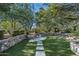 Landscaped backyard with firepit and stone retaining walls at 20242 N 103Rd Way # 1246, Scottsdale, AZ 85255