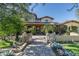 Stunning two-story home with stone accents and a tile roof, showcasing a beautiful landscape at 20242 N 103Rd Way # 1246, Scottsdale, AZ 85255