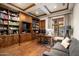 Home library featuring custom wood cabinetry, ample shelving, and a comfortable workspace at 20242 N 103Rd Way # 1246, Scottsdale, AZ 85255