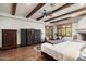 Spacious bedroom with hardwood floors, a ceiling fan, and access to a private balcony at 20242 N 103Rd Way # 1246, Scottsdale, AZ 85255
