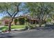 House exterior view showcasing a Spanish-style home with lush landscaping at 20242 N 103Rd Way # 1246, Scottsdale, AZ 85255