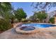 Luxury backyard oasis featuring a sparkling pool, spa, and stone patio at 20242 N 103Rd Way # 1246, Scottsdale, AZ 85255