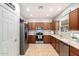 Kitchen with wooden cabinets, stainless steel appliances, and tile flooring at 980 S 220Th Ln, Buckeye, AZ 85326
