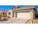 House exterior with a two car garage and desert landscaping at 980 S 220Th Ln, Buckeye, AZ 85326
