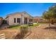 Landscaped backyard with grass, gravel, and pergola at 980 S 220Th Ln, Buckeye, AZ 85326