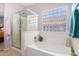 Clean bathroom with soaking tub and glass shower enclosure at 980 S 220Th Ln, Buckeye, AZ 85326