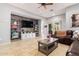 Living room with wood-look wall, sectional sofa, and built-in shelving at 980 S 220Th Ln, Buckeye, AZ 85326
