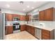 Kitchen with wooden cabinets, stainless steel appliances, and tile flooring at 980 S 220Th Ln, Buckeye, AZ 85326