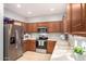 Kitchen with wooden cabinets, stainless steel appliances, and tile flooring at 980 S 220Th Ln, Buckeye, AZ 85326