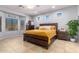 Main bedroom with a large bed, dresser, and bay window at 980 S 220Th Ln, Buckeye, AZ 85326