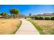 Paved pathway leads to playground in a grassy community area at 980 S 220Th Ln, Buckeye, AZ 85326