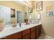 Stylish bathroom with wood vanity, decorative accents and mirror at 980 S 220Th Ln, Buckeye, AZ 85326